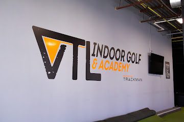 Swing Catalyst force plates installed in the floor with TrackMan screen behind