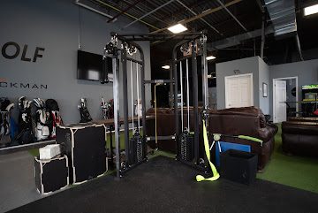 Dumbbell rack, kettlebells, and whiteboard with drill programming