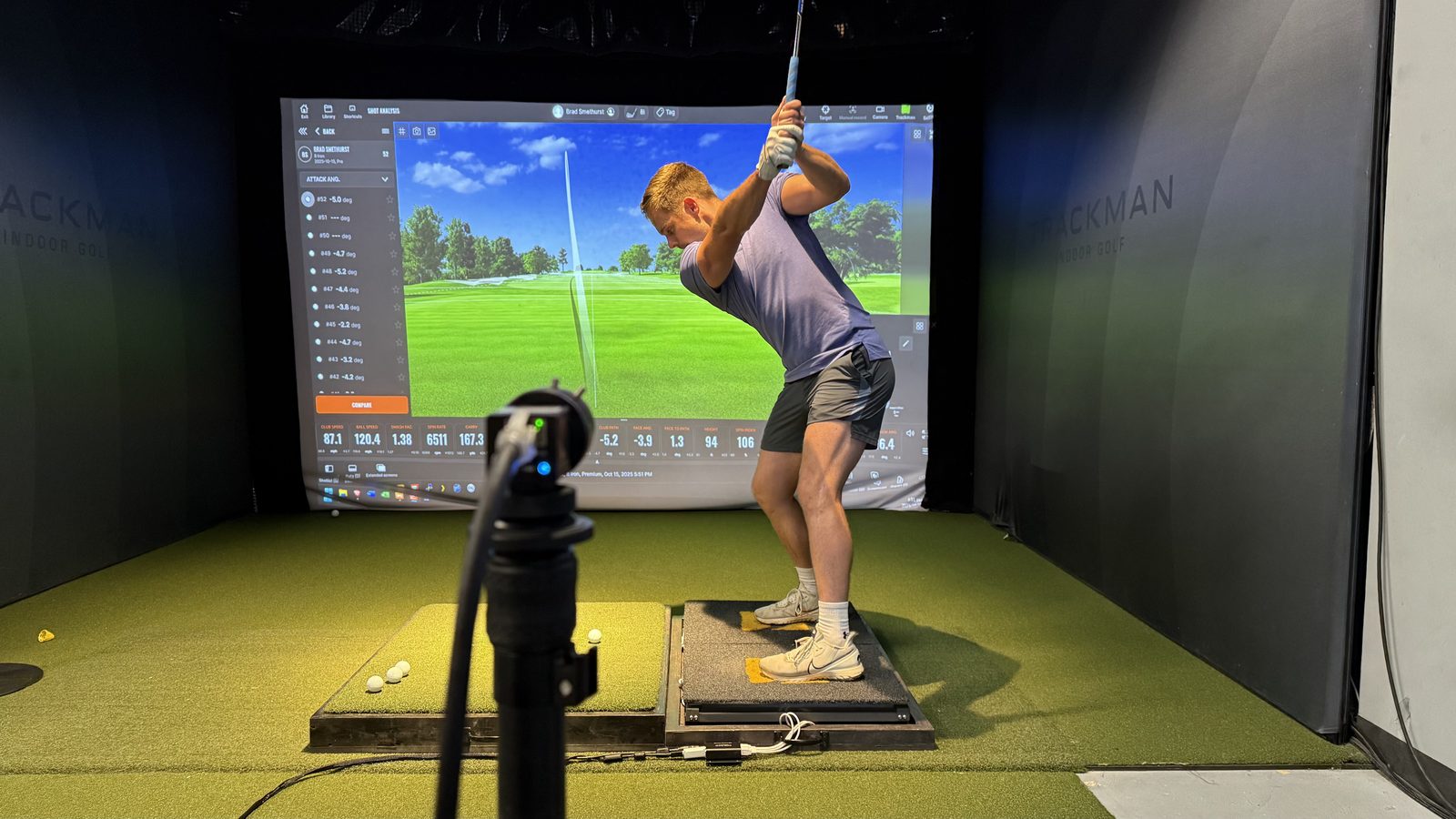Dave Lambert coaching a student mid-swing with Swing Catalyst data on screen