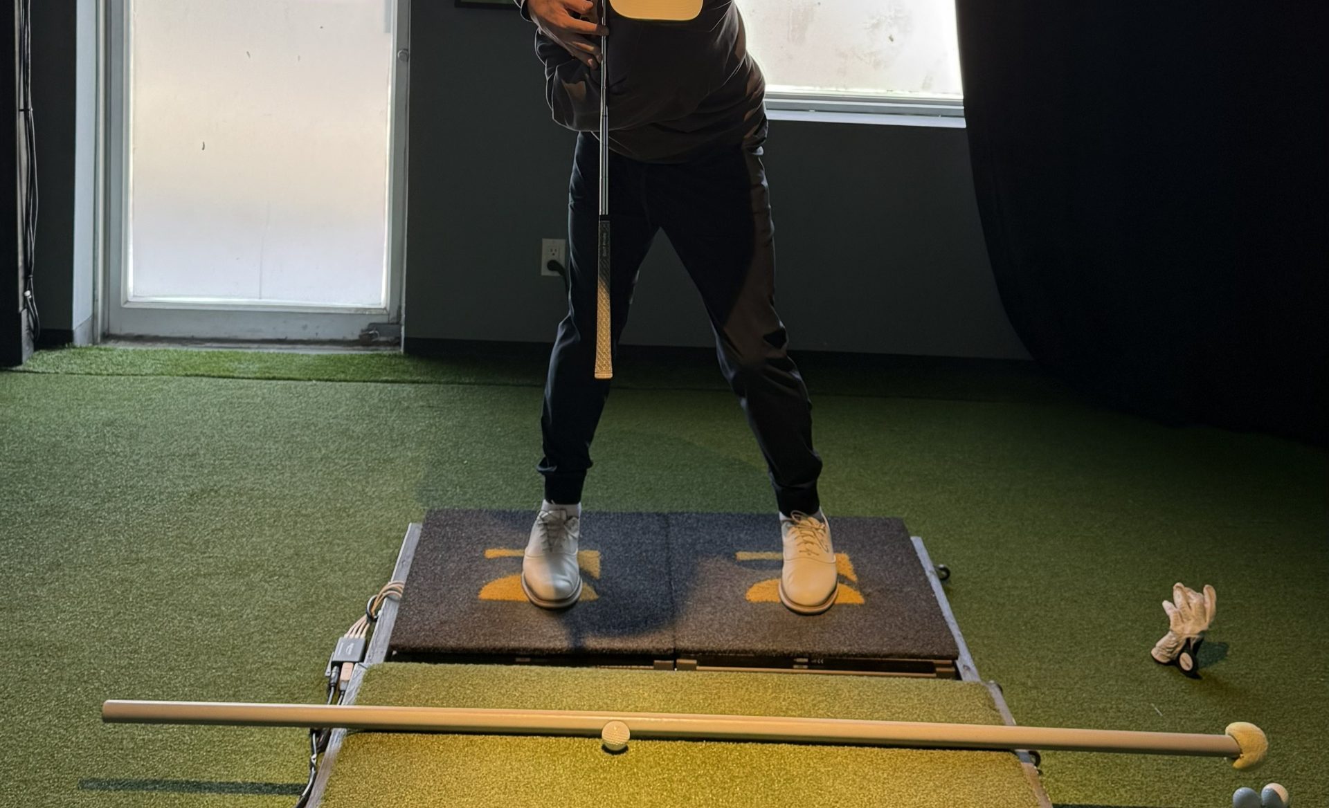 Student mid-backswing at Dave Lambert Golf with TrackMan tracking